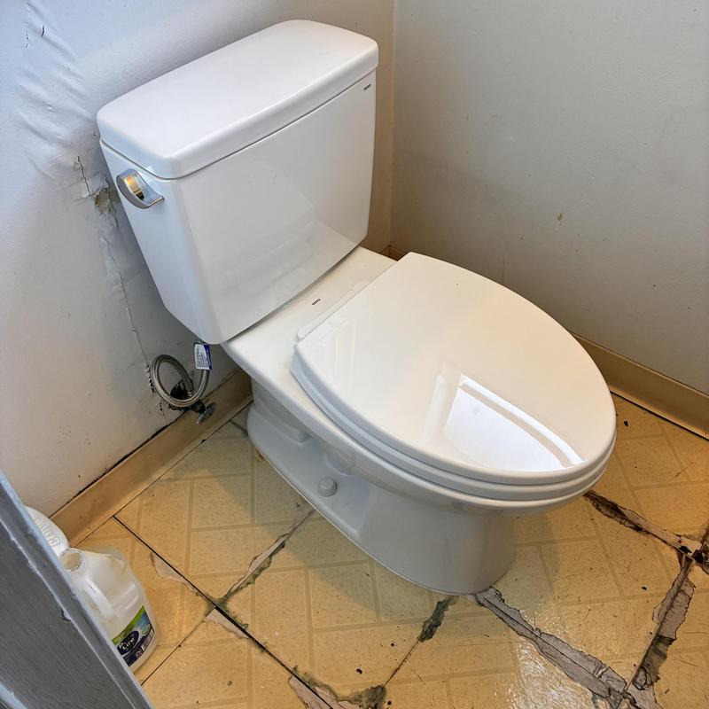 Toto elongated toilet installed and secured in bathroom