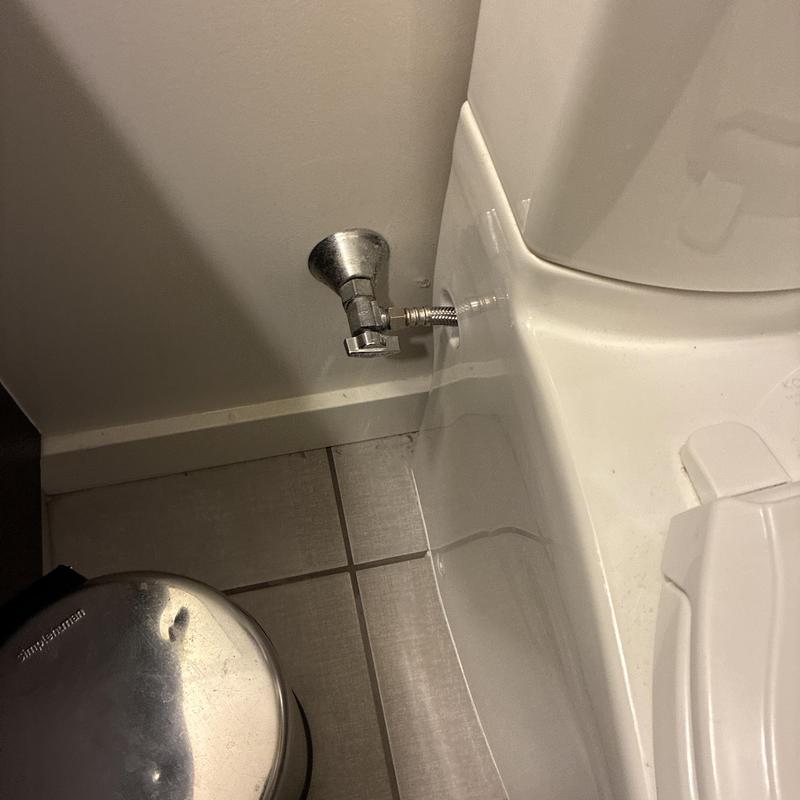 Toilet water supply line installation near tank