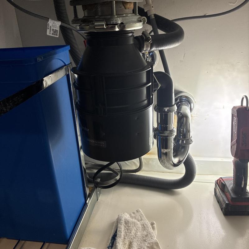 Garbage disposal and drain pipes under kitchen sink