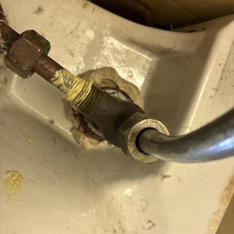 Wall-mounted sink water line connections with sealant
