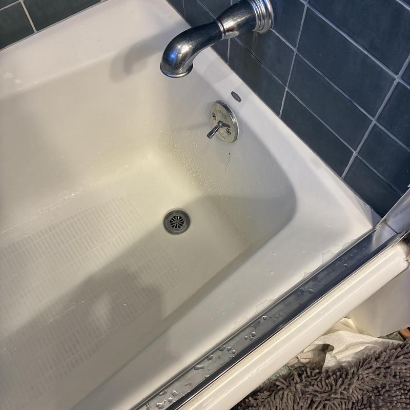 Shower drain with cleaned clog and flowing water