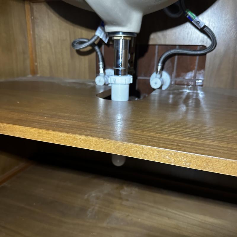 Bathroom sink drain pipe and flexible water supply lines under cabinet