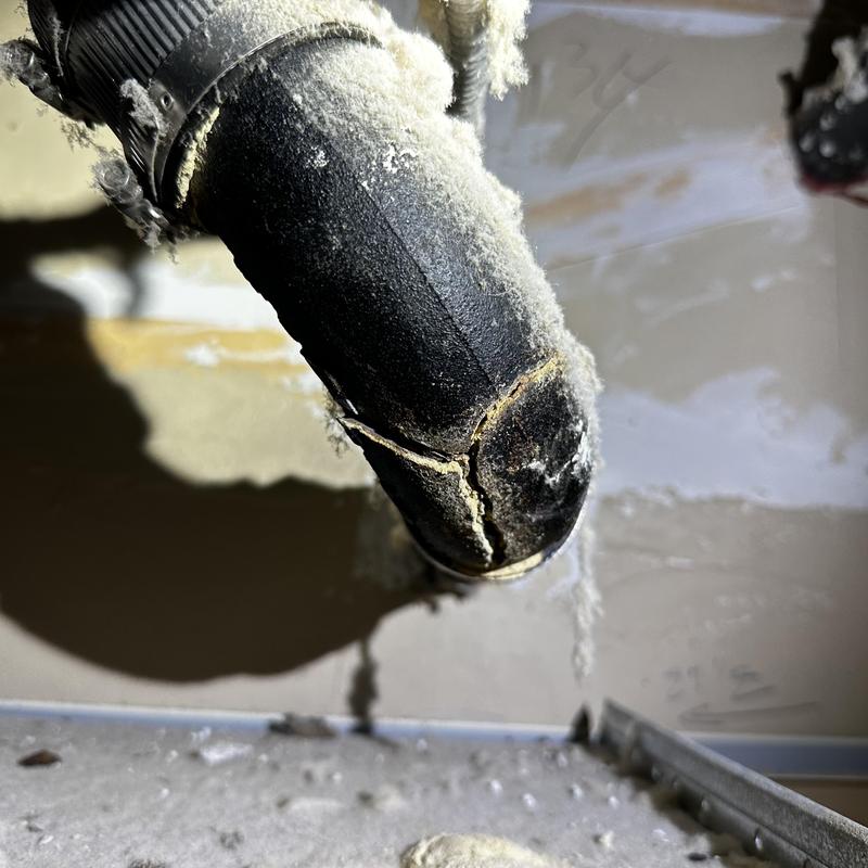 Cast-iron vent pipe with large visible crack