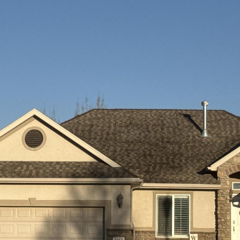 Asphalt shingle roof on residential home exterior Asphalt shingle roof on residential home exterior