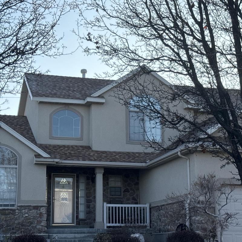 Asphalt shingle roof on two-story house exterior Asphalt shingle roof on two-story house exterior