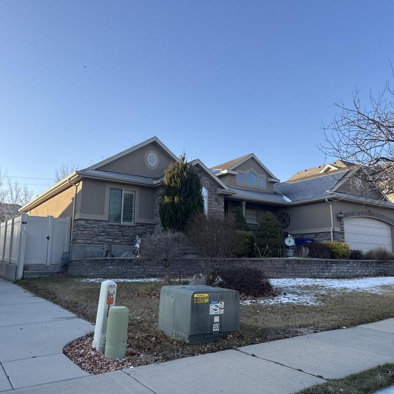 Asphalt shingle roof on residential home in winter Asphalt shingle roof on residential home in winter