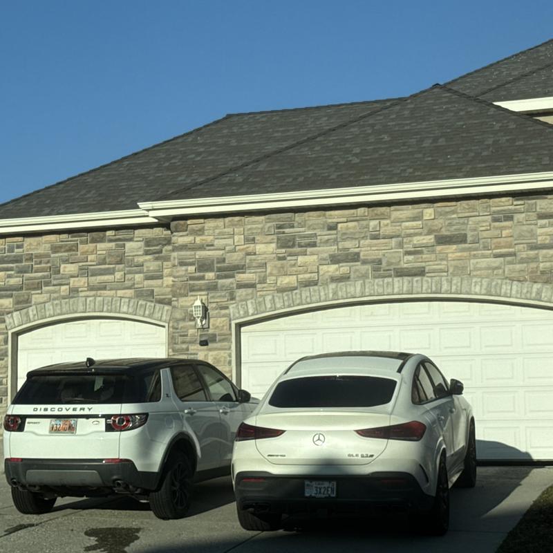 Asphalt shingle roof on residential home in sunlight Asphalt shingle roof on residential home in sunlight