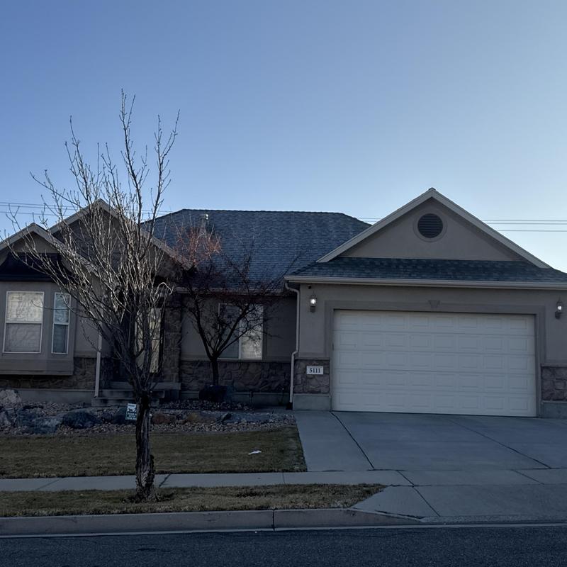Asphalt shingle roof on suburban home exterior Asphalt shingle roof on suburban home exterior