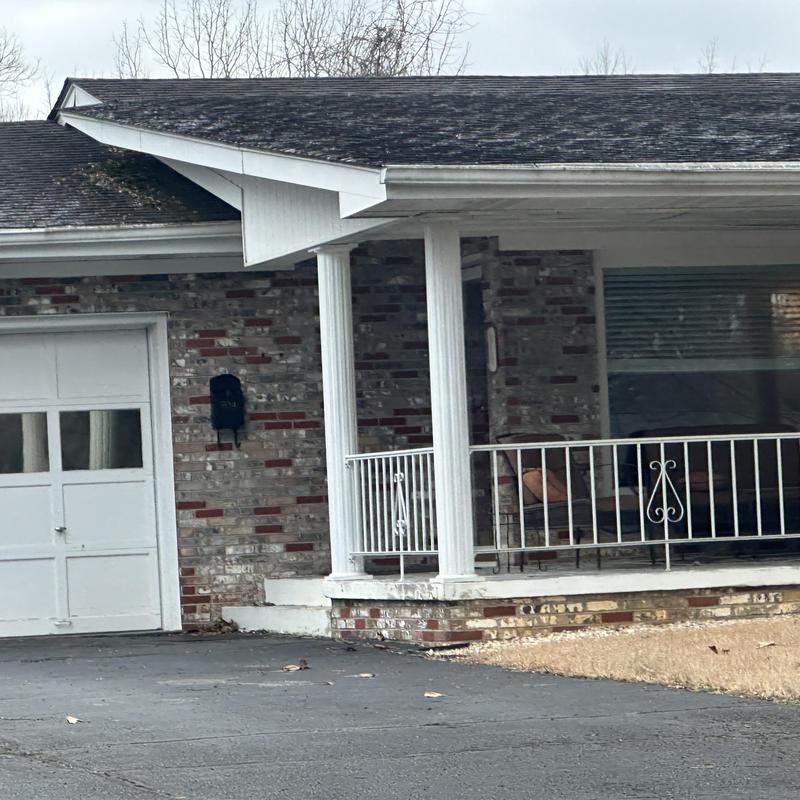 Asphalt shingle roof with gutter on brick house