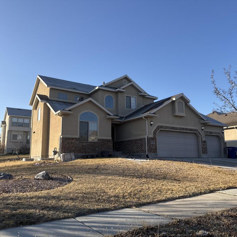 Asphalt shingle roof on suburban home in sunlight Asphalt shingle roof on suburban home in sunlight