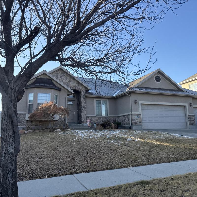 Asphalt shingle roof on suburban home in winter Asphalt shingle roof on suburban home in winter