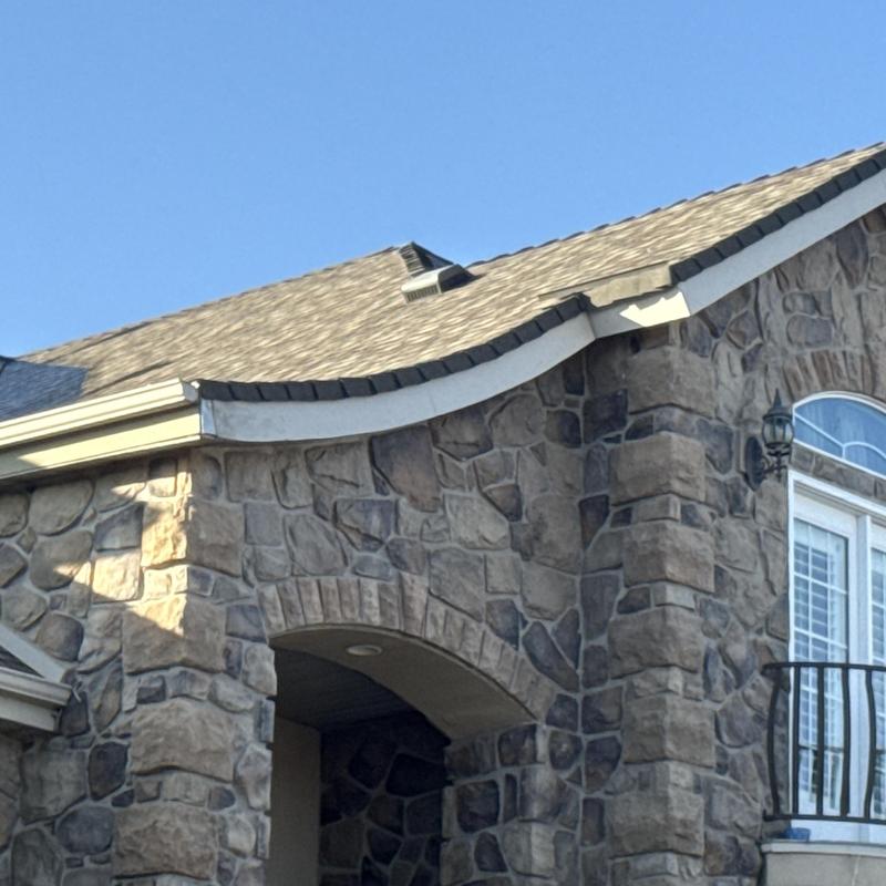 Asphalt shingle roof on stone facade home Asphalt shingle roof on stone facade home