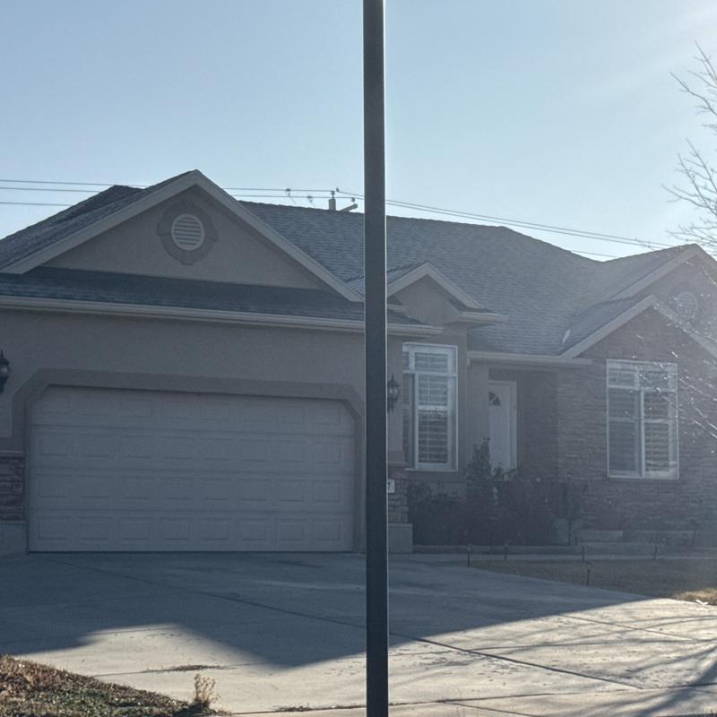 Asphalt shingle roof on suburban house in West Valley City Asphalt shingle roof on suburban house in West Valley City