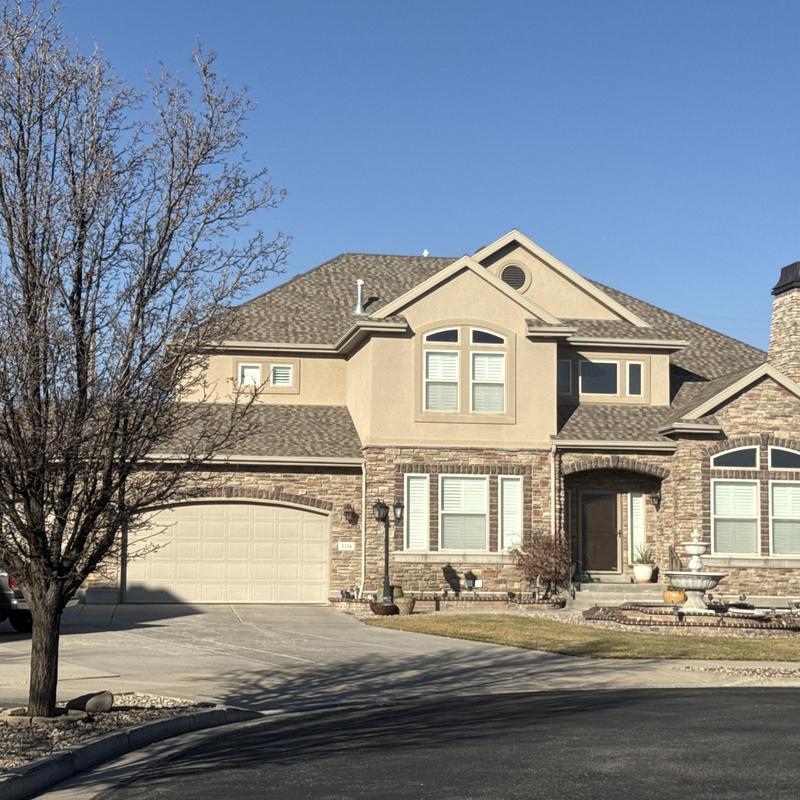 Asphalt shingle roof on suburban home, clear sky Asphalt shingle roof on suburban home, clear sky