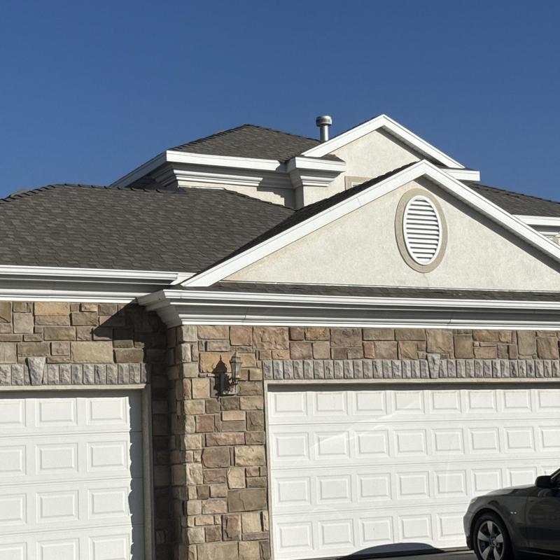 Asphalt shingle roof on residential garage and house Asphalt shingle roof on residential garage and house