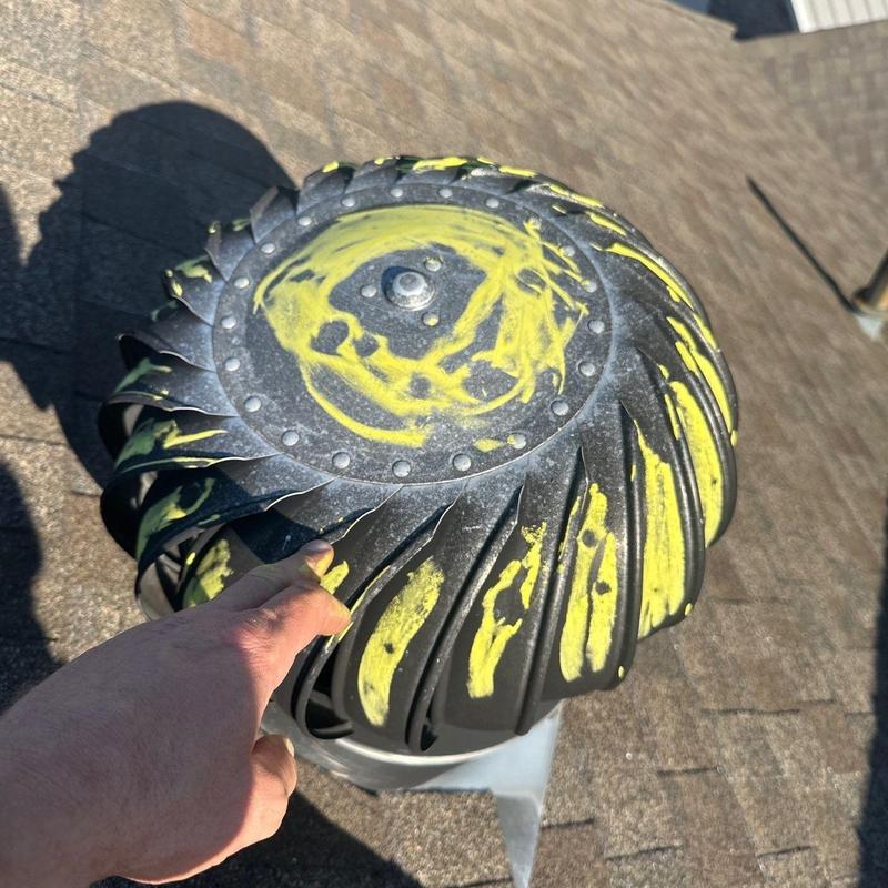 Turbine roof vent with yellow hail damage markings