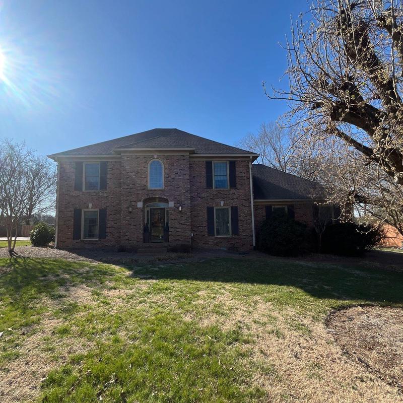 Roof shingles hail damage inspection on brick house