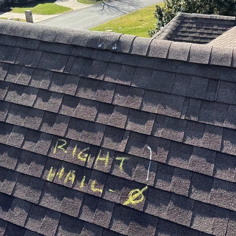 Asphalt shingle roof with hail damage markings