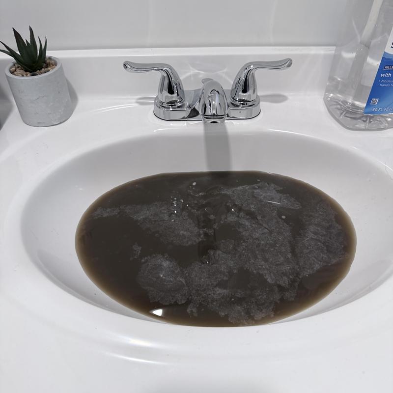 Bathroom sink drain with backed-up dirty water