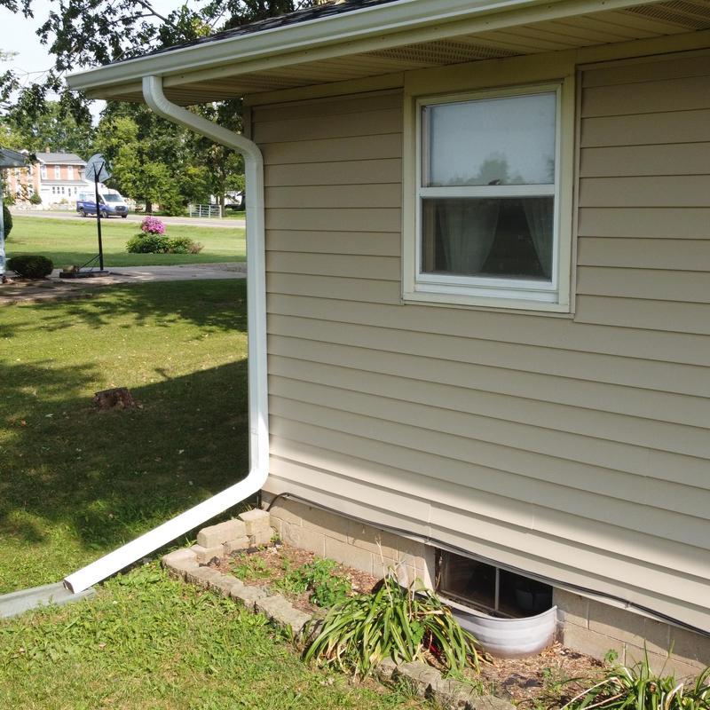 Seamless aluminum gutter and downspout system on house Seamless aluminum gutter and downspout system on house