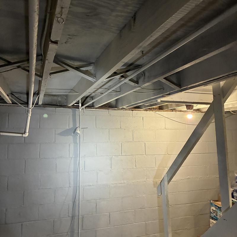 Basement drain pipes and plumbing installation under joists