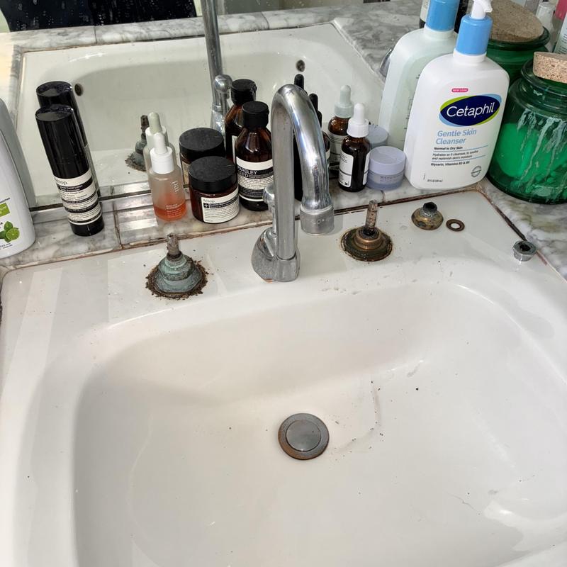 Old Chicago widespread faucet with removed handles and corrosion