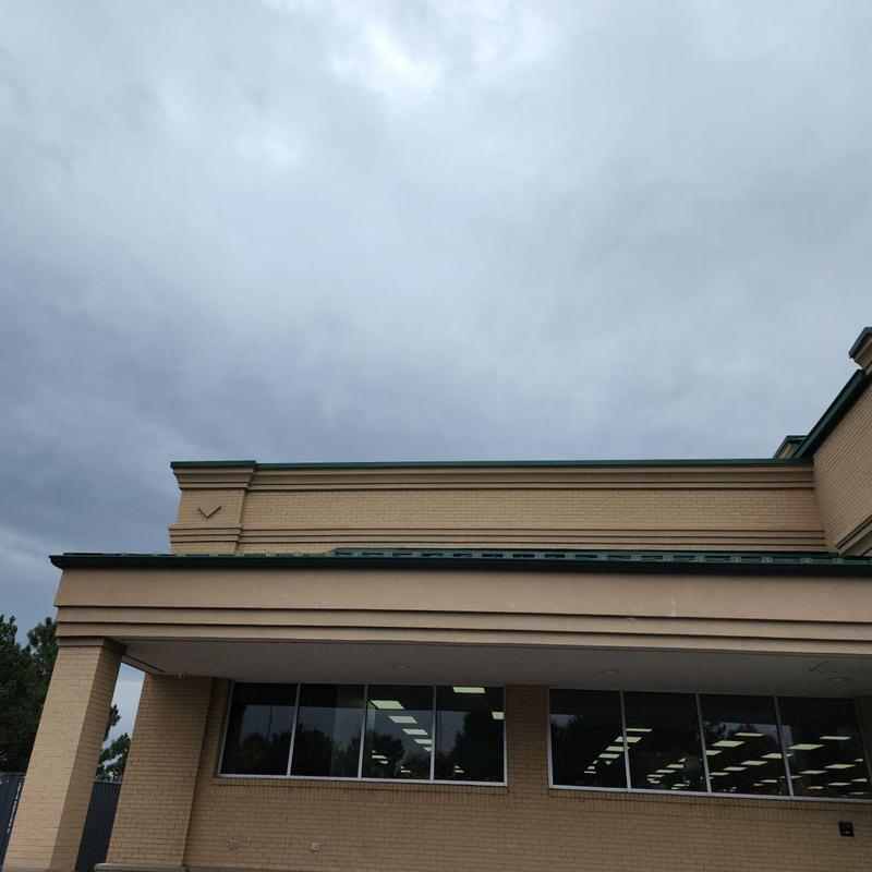 Metal roof panel ridges and gutters cleaning at building Metal roof panel ridges and gutters cleaning at building