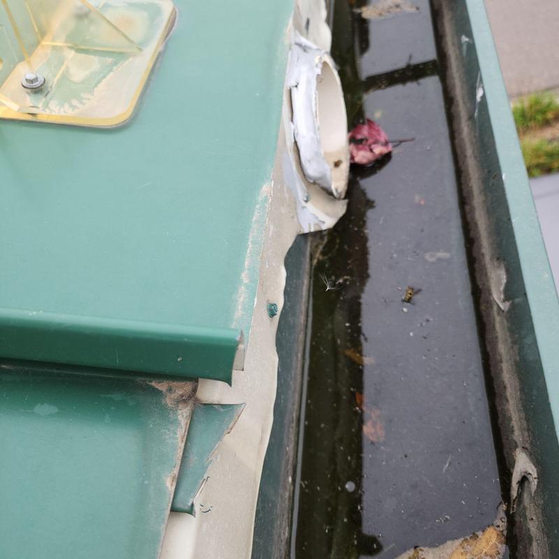 Metal roof pipe jack sealing near clogged gutter Metal roof pipe jack sealing near clogged gutter