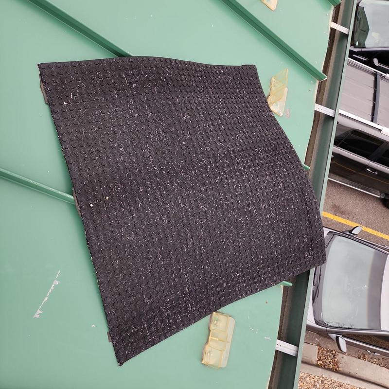 Metal roof panel with black textured sealant pad Metal roof panel with black textured sealant pad