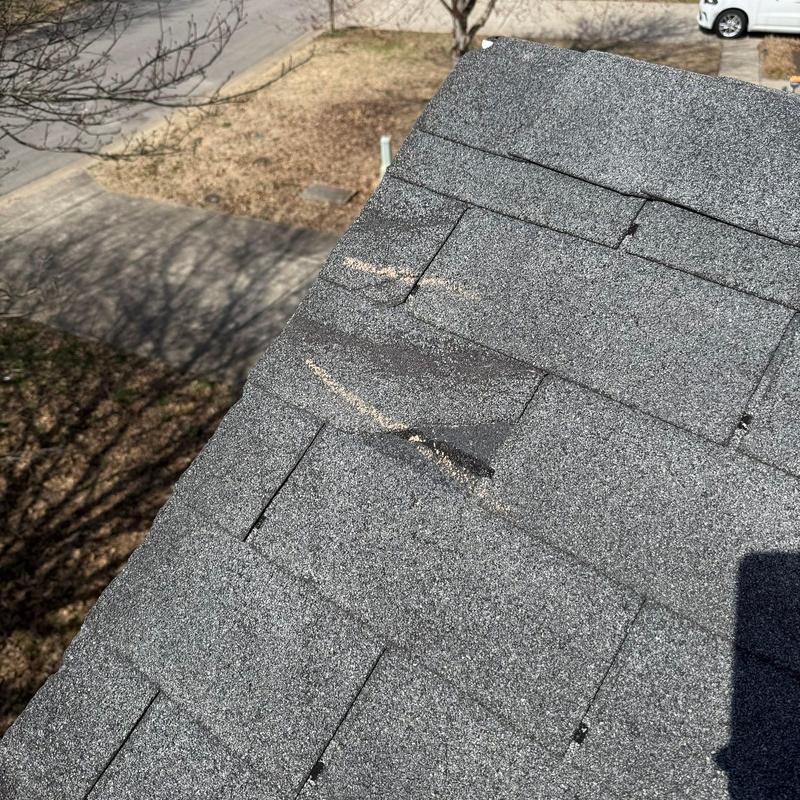 Asphalt shingles with hail damage on roof edge