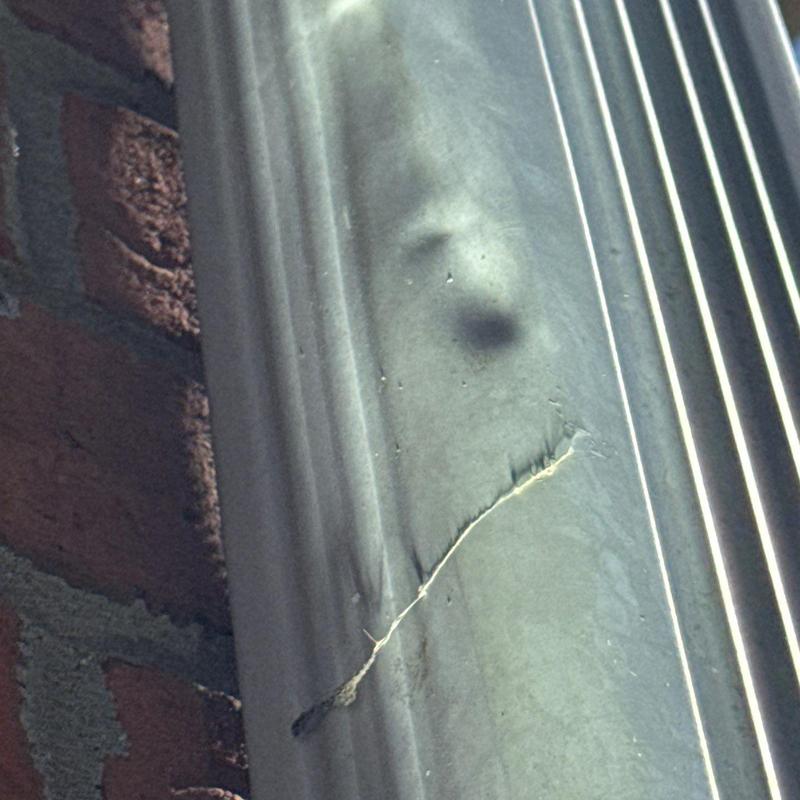 Asphalt shingle hail damage and cracked metal flashing