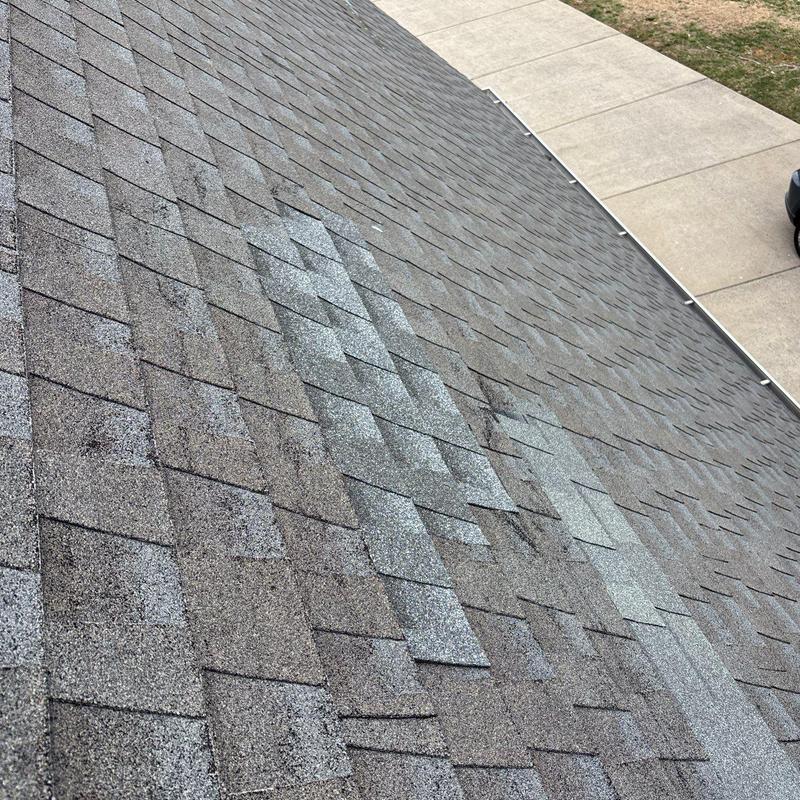 Asphalt roof shingles with hail damage and wear