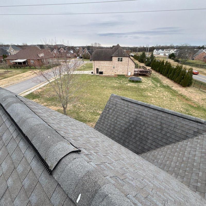 Roof ridge and shingles hail damage inspection view