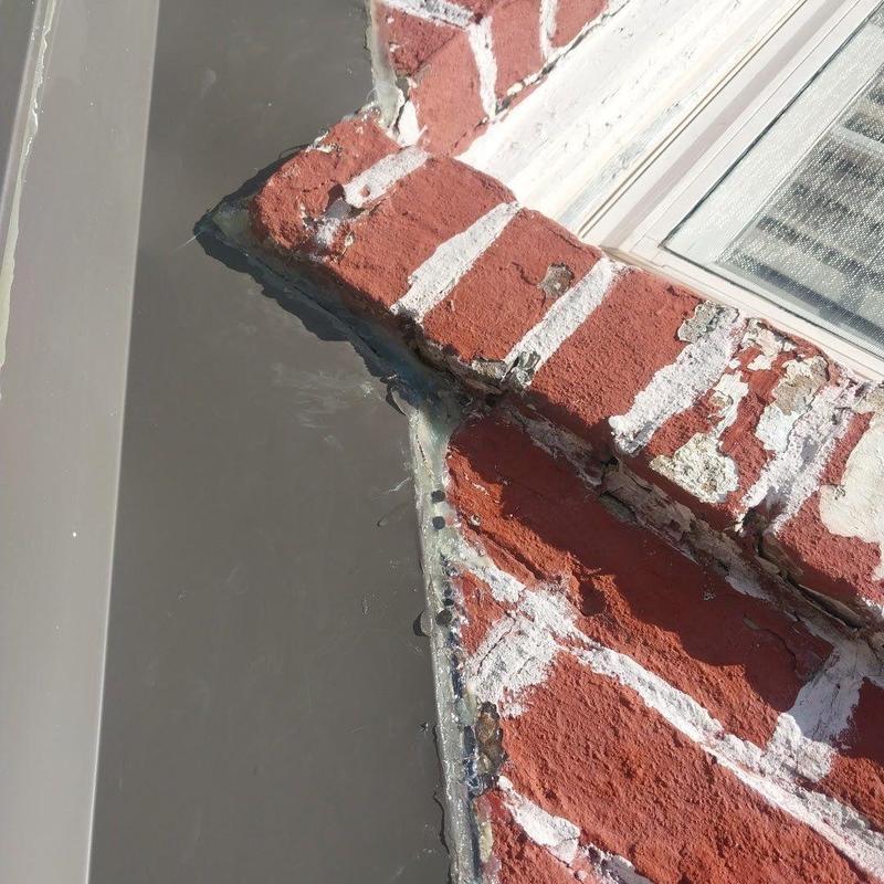 Brick wall flashing with sealant and mortar deterioration