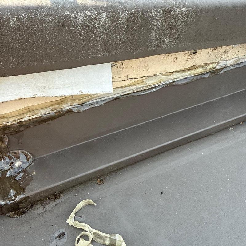 Metal flashing with deteriorated sealant and damage