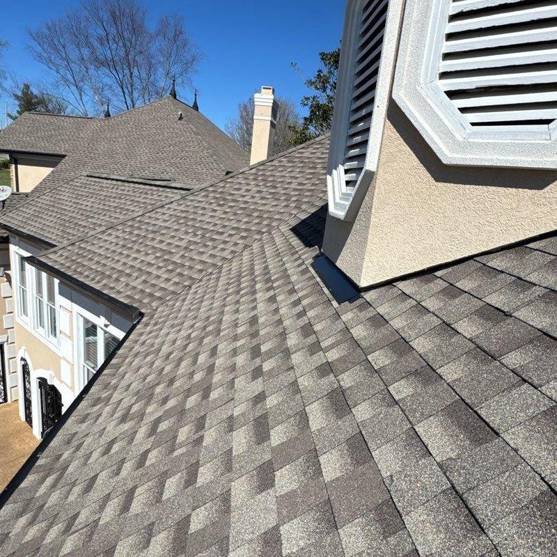 Asphalt shingle roof with chimney flashing and vents
