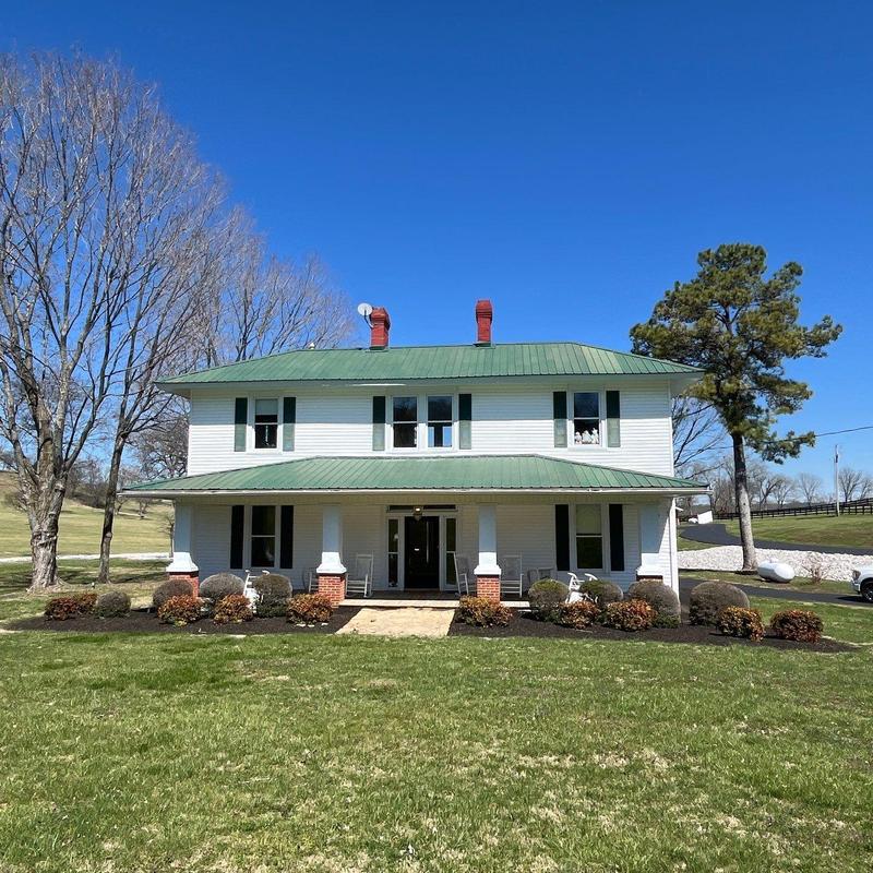 Metal roof with chimney ventilation inspection on house