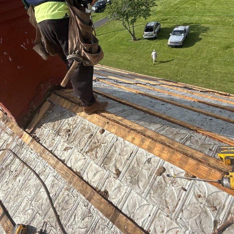 Roof decking inspection and preparation on a pitched roof
