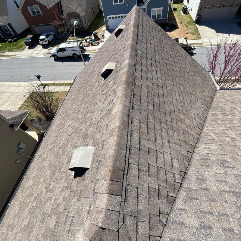 Asphalt shingle roof with ridge caps and vents inspection