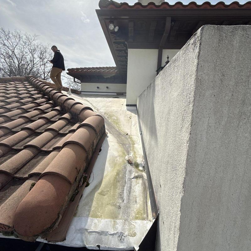 Roof flashing and tile inspection on sloped roof