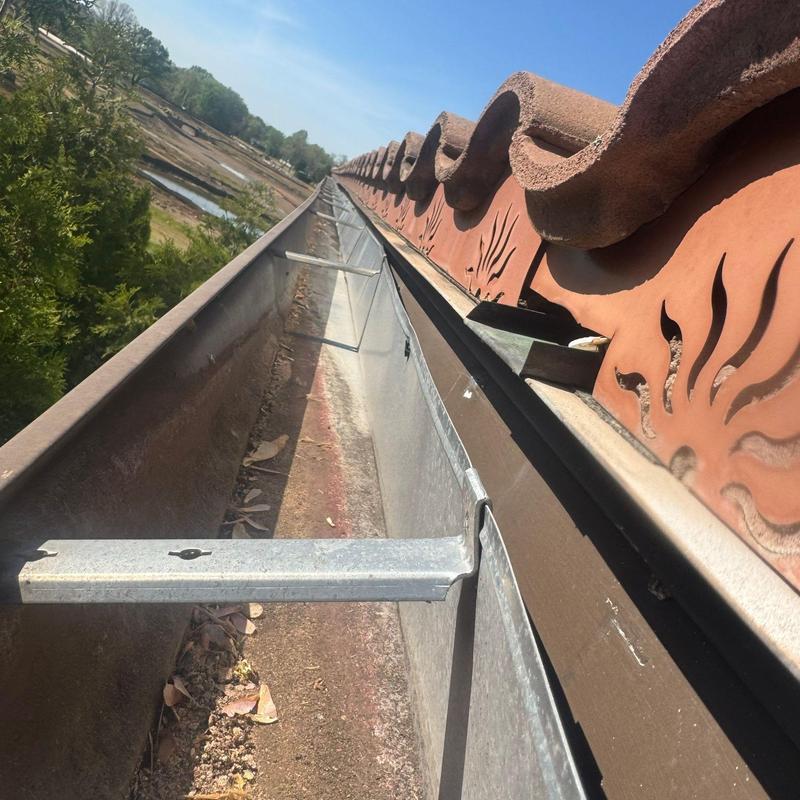 Clay tile roof gutter with metal support brackets