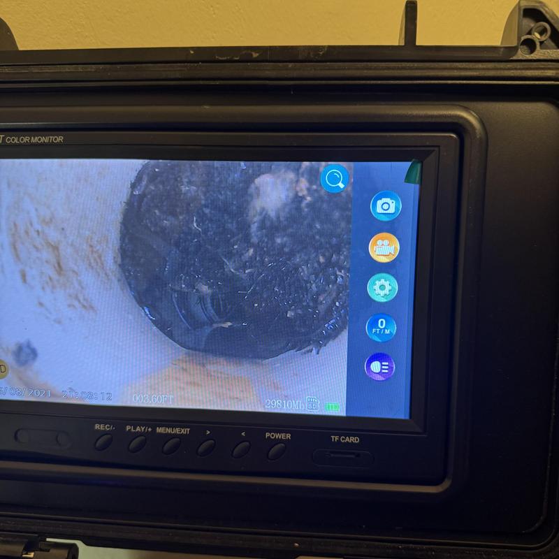 Main sewer pipe camera inspection showing clog buildup