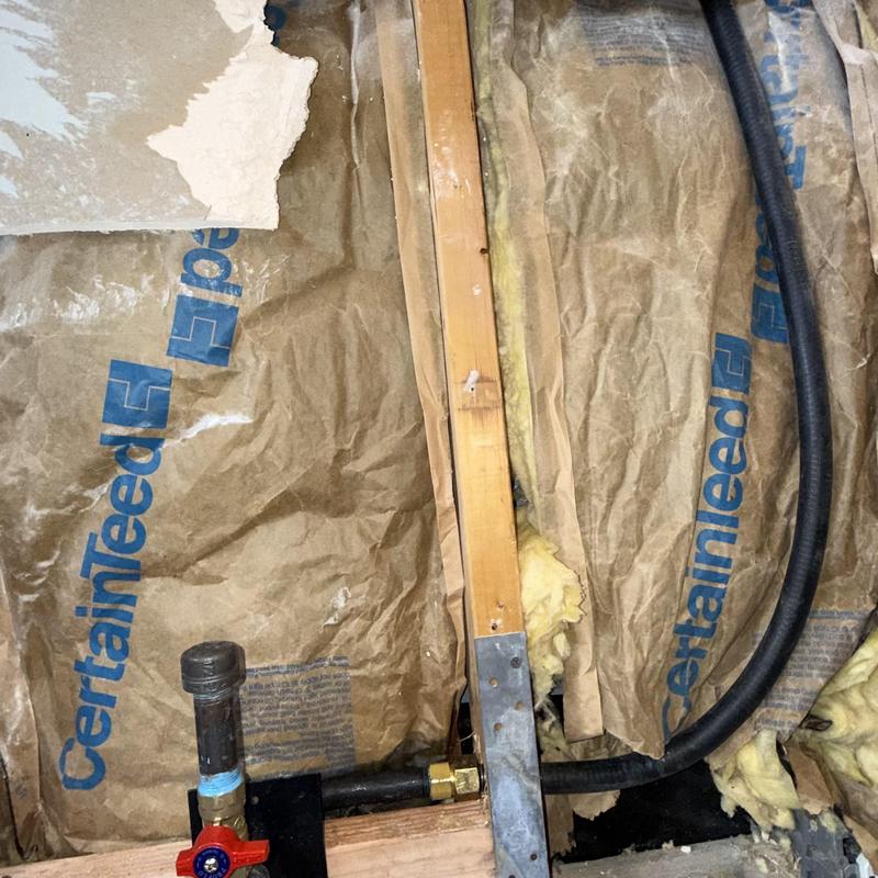 Flexible gas line installation in wall cavity