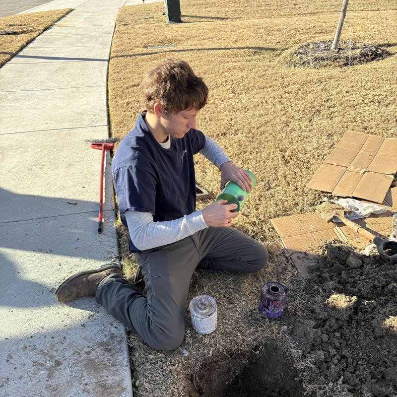 Sewer cleanout pipe with adhesive in outdoor repair