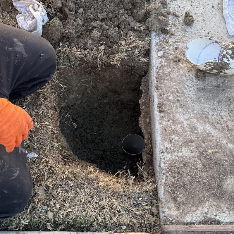 Sewer cleanout excavation next to sidewalk repair