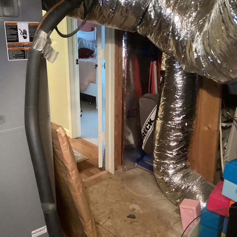 HVAC ductwork with insulation in basement room