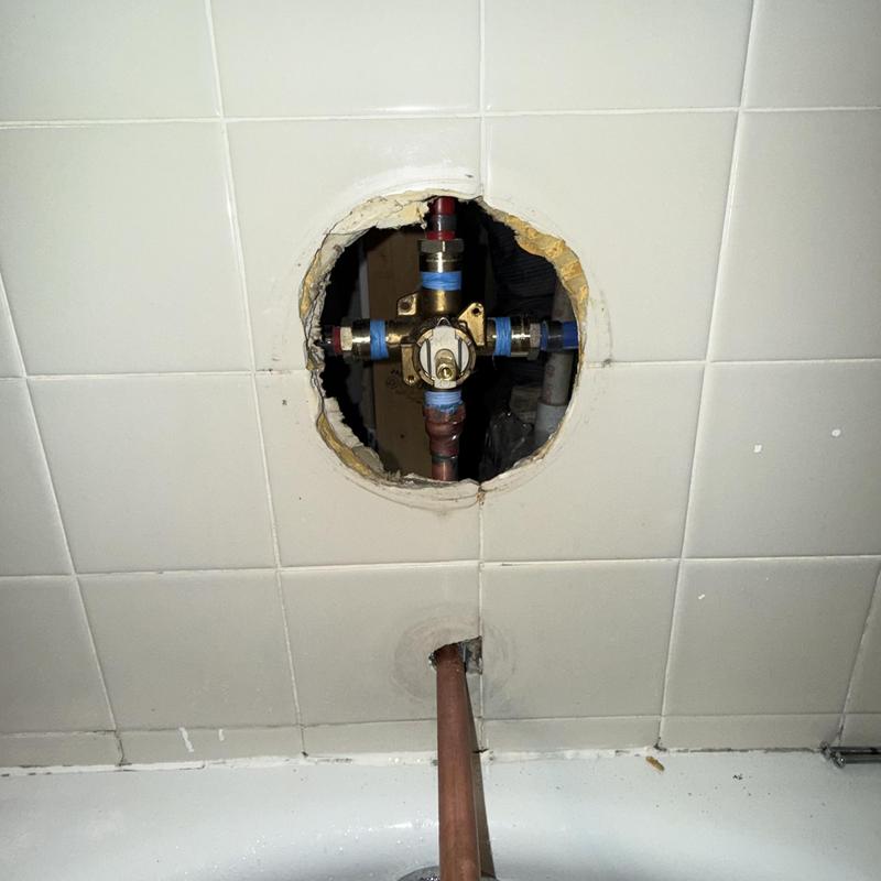 Tub and shower valve installation behind tile wall