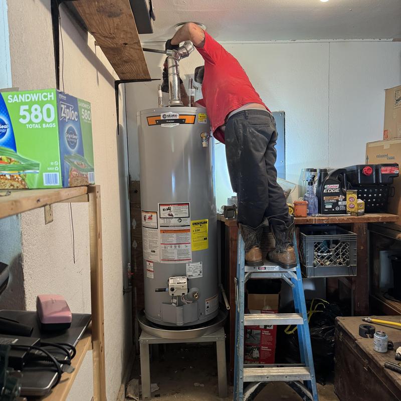 Gas water heater installation in residential garage
