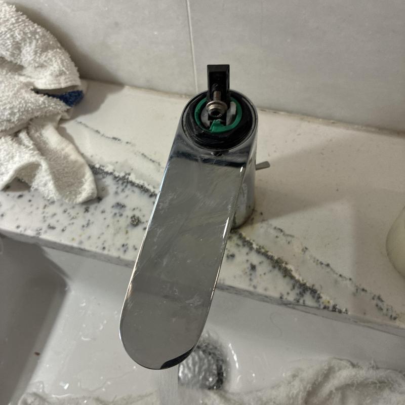 Basin faucet with cartridge retightened on marble sink