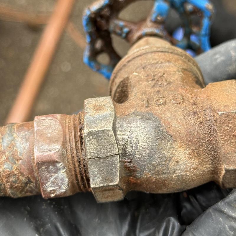 Outdoor water shut off valve with visible crack